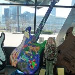Taylor poses with a giant guitar.