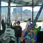 Trevor poses with a giant guitar.