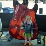 Tess poses with a giant guitar.