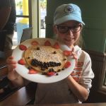 Tess shows off her breakfast at The Pancakery