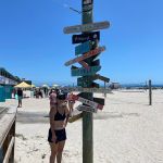 Mom by the sign near the pier