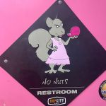 Women's restroom sign at beach bar
